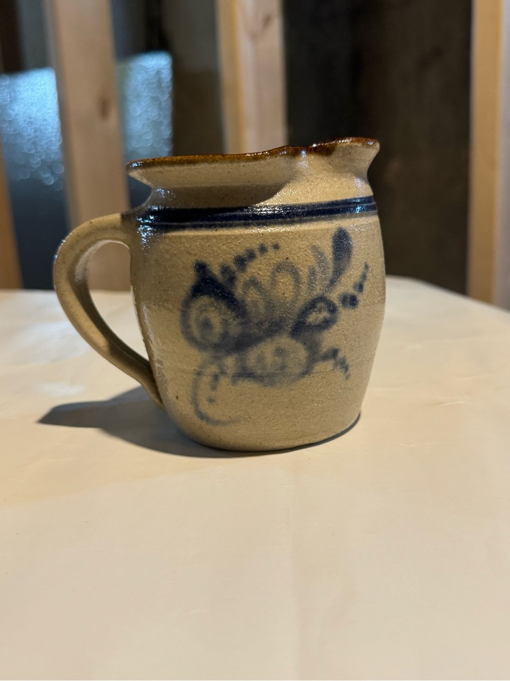 Handcrafted Stoneware Pitcher with Blue Floral Accent